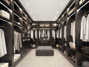 a walk-in closet with wood paneling, hanging rods, shoe racks, and soft lighting